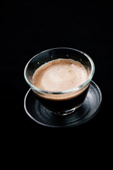 Cup of espresso on black background. Copy space. 
