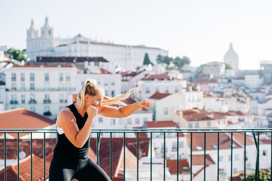 Woman shadow boxing early in the morning in Lisbon