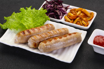 Grilled sausages served mushrooms and cabbage