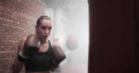 Female exercising with a a punch bag
