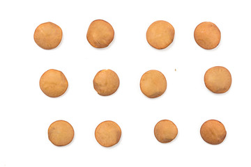 Isolated stack of uncooked lentils on white background from above.
