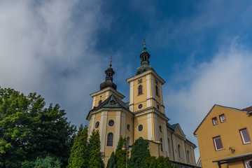 Fototapeta na wymiar Church of Assumption of saint Mary in Kynsperk nad Ohri town in summer morning