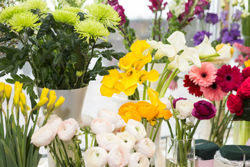 Yellow and white callas, green chrysanthemum, yellow narcissus, pastel pink peony roses. Multicolored flowers.