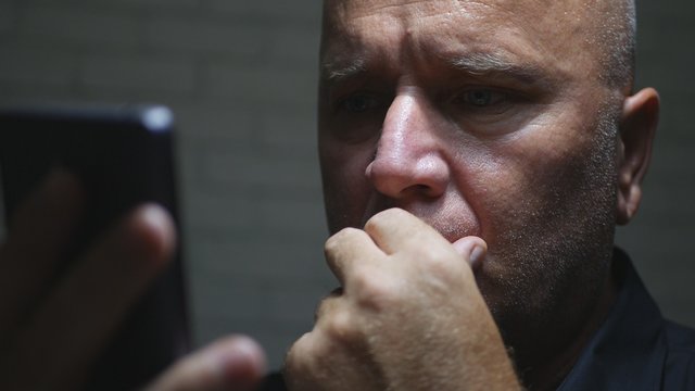 Worried Businessman Image in Darkness Using Smartphone Wireless Communication