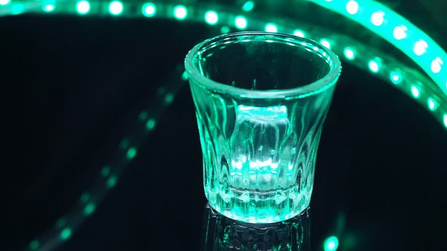 A Bartender Pours Liquor In Shot Glass With Slice Of Lemon Inside