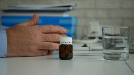 Businessman in Office Suffering a Big Headache Take Medical Pills