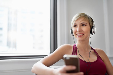 Trendy woman listening to a meditaion app as part of her mindfulness morning routine