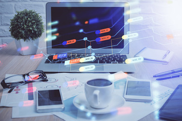 Double exposure of table with computer on background and data theme hologram. Data technology concept.