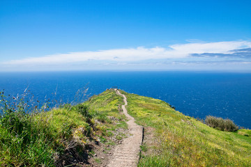 Fototapeta na wymiar The viewpoint near the Chapel of Nossa Senhora da Boa Morte near Atlantic ocean in summer with blue skyline in Madeira, Portugal 