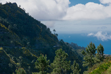 Fototapeta na wymiar Panoramic mountains view from Eira do Serrado viewpoint down to The Atlantic ocean and Funchal city. Madeira Island in summer