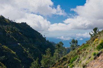 Fototapeta na wymiar Panoramic mountains view from Eira do Serrado viewpoint down to The Atlantic ocean and Funchal city. Madeira Island in summer