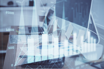 Stock market chart hologram drawn on personal computer background. Multi exposure. Concept of investment.