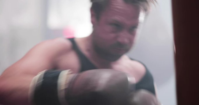 Male boxer punching a punch bag