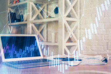 Fototapeta premium Financial chart drawing and table with computer on background. Double exposure. Concept of international markets.