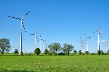 Fototapeta na wymiar Wind turbines and green fields seen in Germany