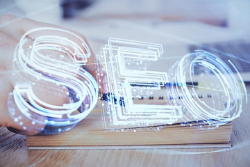 Man writing. With double exposure seo drawings.