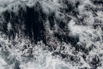 Sea, ocean, wave. Beautiful view of the bubbling and splashing sea water and foam in the blue sea.