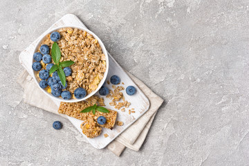 Oat flakes with fresh blueberry and granola bar for healthy nutrition