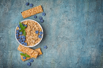 Oat flakes with fresh blueberry and granola bar for healthy breakfast