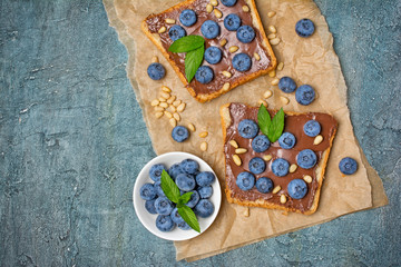 Sandwiches with chocolate spread, pine nuts and blueberries