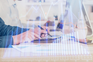 Forex graph with businessman working on computer in office on background. Concept of hardworking. Closeup. Multi exposure.