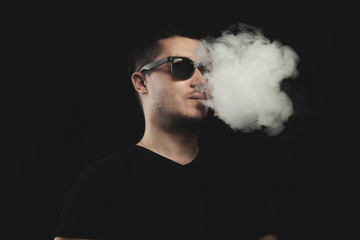 Vaping man and a cloud of vapor