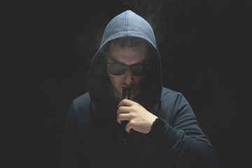 Vaping man and a cloud of vapor