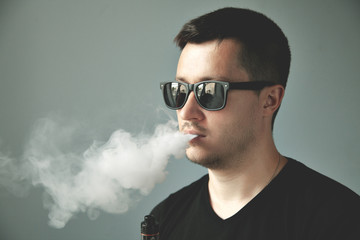 Vaping man and a cloud of vapor