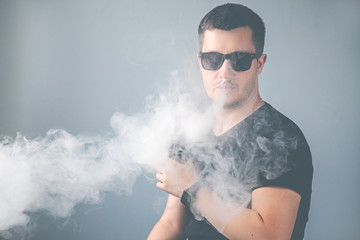 Vaping man and a cloud of vapor