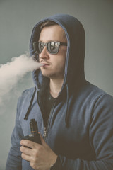 Vaping man and a cloud of vapor