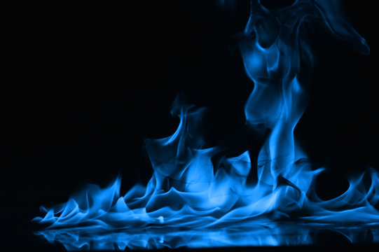 Beautiful fire blue flames on a black background.