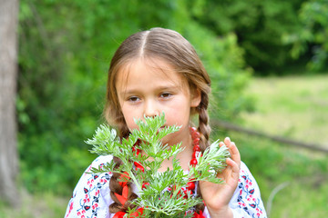portrait of Ukrainian Beautiful girl in vyshivanka in field with sagebrush .Concept of national traditions