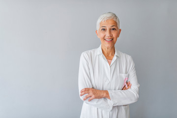 Senior female doctor. Woman doctor smiling and looking to the camera. Portrait of beautiful mature female doctor looking at camera. Beautiful female doctor. Medical concept