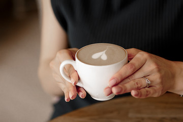 female hands hold coffee