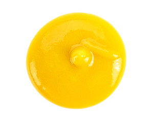 Mustard sauce on a white background, top view.