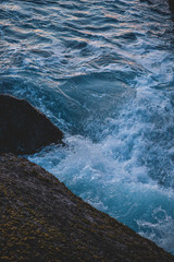 Fototapeta na wymiar waves hitting rock shore