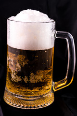 glass of beer on a black background
