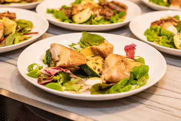Chicken salad with fresh herbs, cherries and Asian dressing. Cooking in a restaurant
