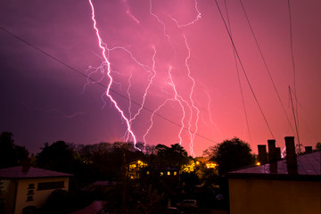 Lightning on the colored sky, roof of a building