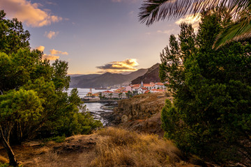 Hidden view on village at the coastline during sunset
