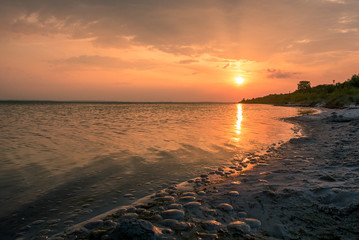 Fototapeta na wymiar Sunset over the sea beach summer evening