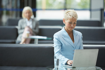 Businesswoman typing on laptop