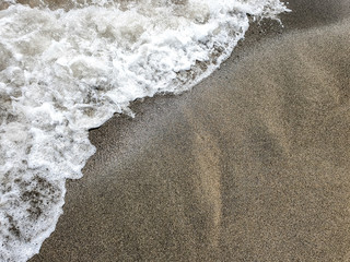 Sea wave on sandy beach