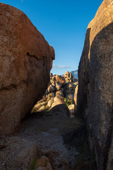 view between boulders while climbing amid rock formations in the Alabama Hills  of Eastern Sierra Nevada mountains California USA