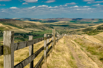 Fototapeta na wymiar Fence and walkpath through the hill