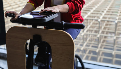 Exercise bike in medical practice. Close-up user hands. 