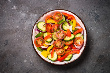 Fototapeta na wymiar Summer fresh vegetable salad top view.