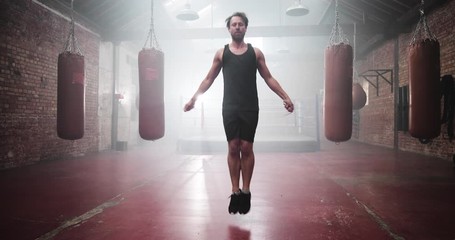 Adult male jumping rope in boxing club