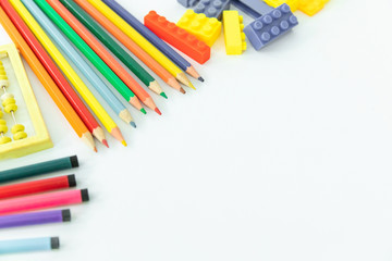 Back to school. School background with supplies. Pencils and school equipment.  Multi-colored objects for drawing. Copy space