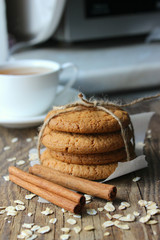 Homemade oatmeal cookies and a Cup of tea on an old wooden table, rustic style. Oatmeal and cinnamon sticks. Copy space.